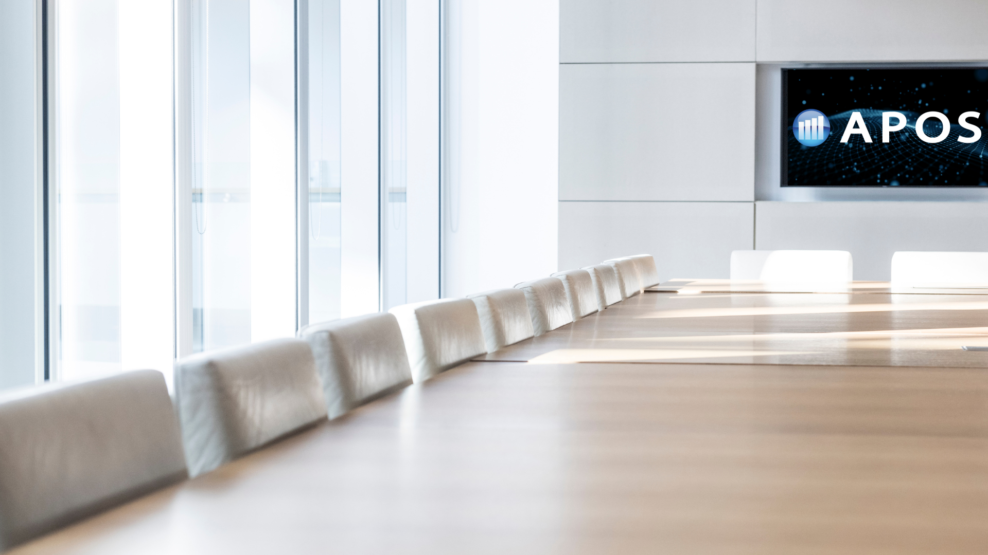 empty boardroom table, windows, simple APOS logo on screen